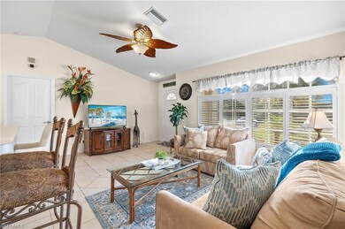 Living room with ceiling fan, light tile patterned