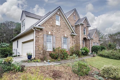 View of property with a front lawn and a garage