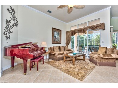 Living room w/view of the pool, lanai and preserve