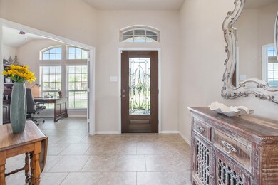 Beautiful entryway with ceramic tile flooring with your home office to the right.