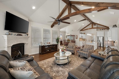 Living room with beamed ceiling, dark wood-type fl