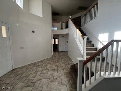 Foyer entrance featuring stairs, stone finish floo