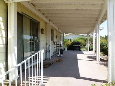 Full length concrete patio with wood patio cover