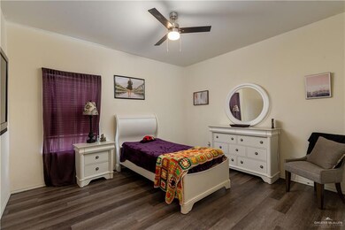 Bedroom featuring ceiling fan and dark wood-style floors
