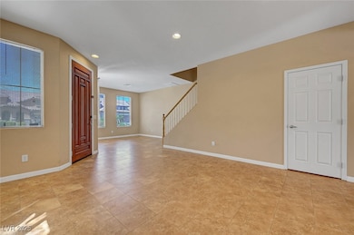 Empty room with recessed lighting, stairs, baseboa