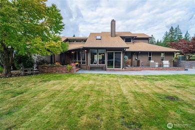 View of the front of the home showing off some of the brand-new windows, deck & patio work.