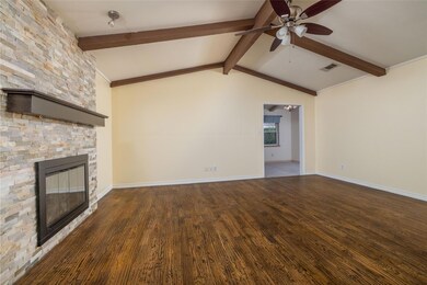 Unfurnished living room with lofted ceiling with b