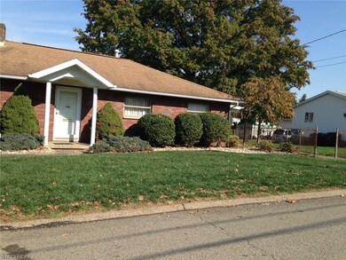 Front of home showing 2-stall garage to the right 