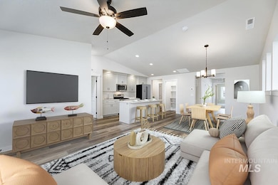 Living area featuring lofted ceiling, a chandelier, light wood-type flooring, a ceiling fan, and recessed lighting
