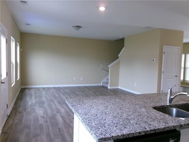 Kitchen featuring a sink, wood finished floors, di