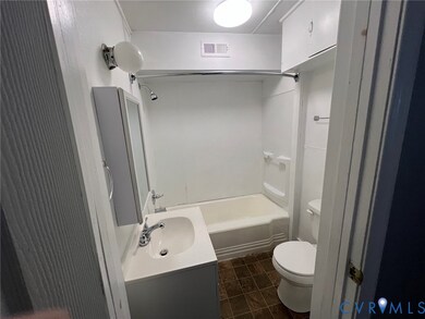 Full bath with vanity, shower / tub combination, and dark tile patterned flooring