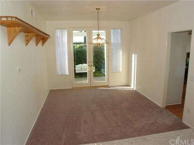Dining Room with new grey carpet and French Doors 