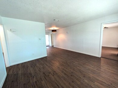 Unfurnished room with dark wood finished floors, 