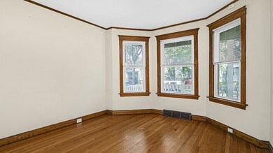 The living room in Unit 1 offers hardwood floors a