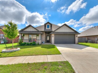 Craftsman-style house with brick siding, driveway,