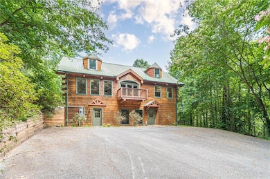 View of front of house with a balcony and metal ro