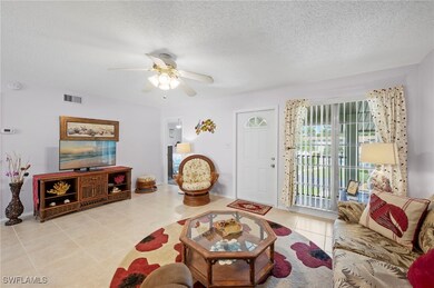 Tiled living area with ceiling fan and a textured