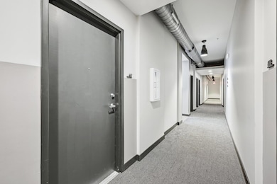 Hallway featuring baseboards and carpet flooring