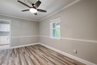 Unfurnished room with ornamental molding, light ha