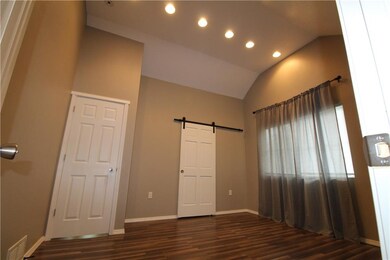 master bedroom with vaulted ceiling