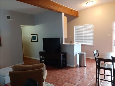 Living room with baseboards, visible vents, and l