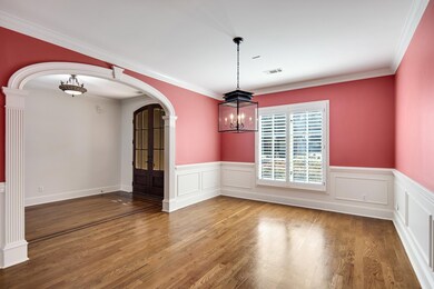 dining area featuring ornamental molding, a chande