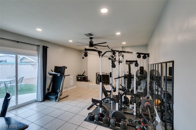 Exercise room featuring a ceiling fan, tile patterned flooring, and recessed lighting