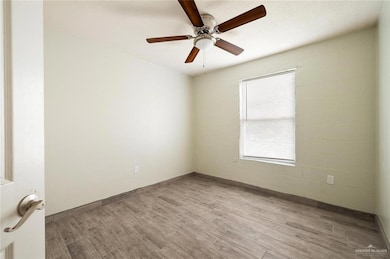 Unfurnished room featuring light hardwood / wood-style flooring and ceiling fan