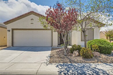 View of front of house with driveway, stucco sidin