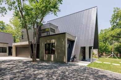Contemporary home featuring a garage and driveway