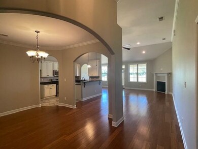 Unfurnished living room featuring dark hardwood / 