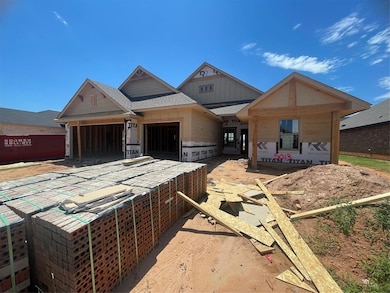 Property under construction with board and batten siding and a shingled roof