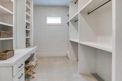 Dual walk in closets with built ins, one of which
