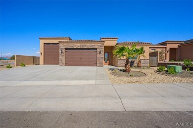 View of front of home with a garage and central AC