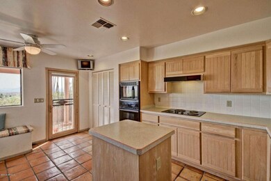 kitchen island, pantry and exit to patio