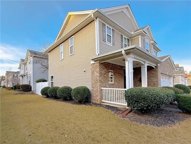 View of side of home featuring brick siding, a porch, a yard, and a residential view