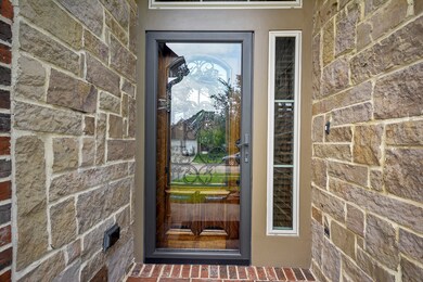 The front door is framed with a glass screened door.