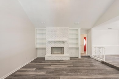 Unfurnished living room with built in shelves, dar
