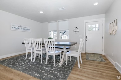 Dining area featuring light wood-type flooring and recessed lighting