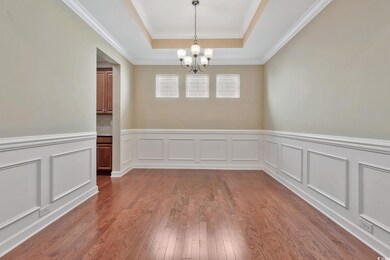 Unfurnished dining room with new paint, wainscotin