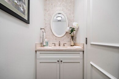 Stylish powder room adjacent to executive foyer.