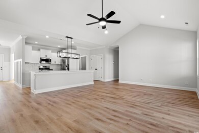 Unfurnished living room featuring ceiling fan, lig