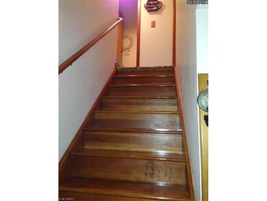 This sparkling wood staircase leads to the bedroom