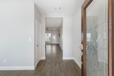 Bright and welcoming entry with stylish stained-glass front door and durable LVP flooring.