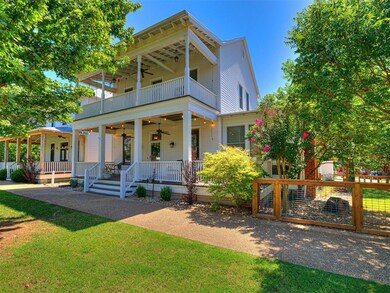 View of front of home with a porch, a balcony, cei