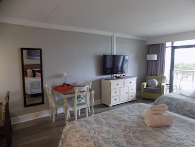 Bedroom with ornamental molding and dark wood-type flooring