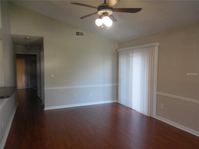 Great room with new engineered hardwood, chair rail, freshly painted interior,  ceiling fan and double-paned sliding door