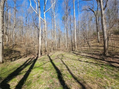 View of grassy area and gravel drive leading to ro