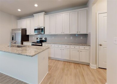 Kitchen featuring stainless steel appliances, a si