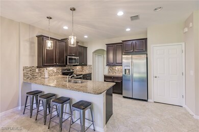 Kitchen featuring decorative light fixtures, stain